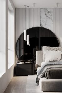 15 a luxurious bedroom with a dark oversized round mirror, a marble and panel accent wall, an upholstered bed with neutral bedding and pendant lamps - Shelterness